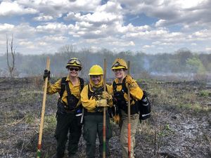 Three of the women who helped lead a controlled burn art Ives Road Fen Preserve in Michigan.