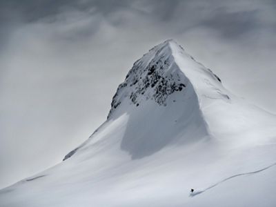 Skier heading down a mountain slope in Slovenia.