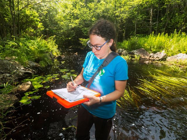 The Nature Conservancy in Massachusetts' Laura Marx records culvert survey data in Becket, Massachusetts. 