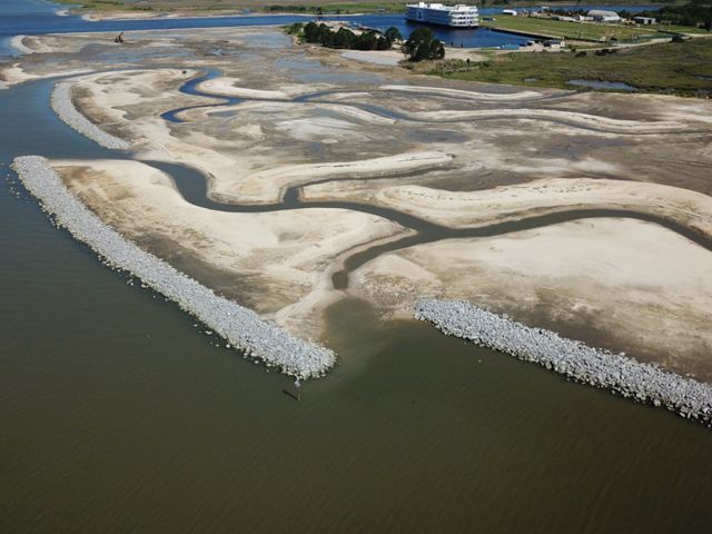 Coastal landscape with reinforced seawall made of rocks.
