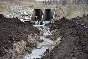 A concrete culvert perched 2 feet the streambed.