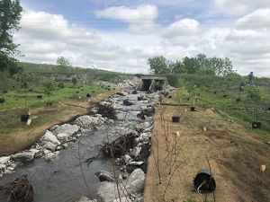 A stream under construction with the bed of the stream at the base of the culvert.