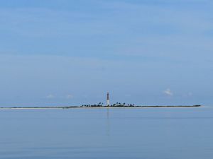 Loggerhead Key lighthouse amid calm seas.