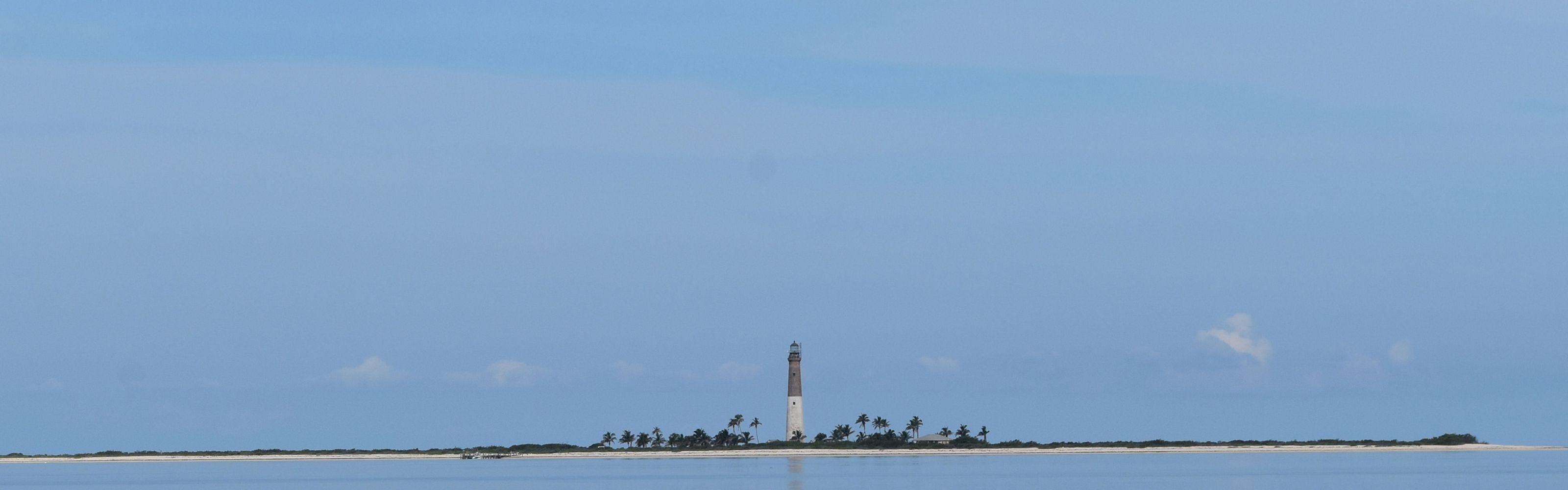 Loggerhead Key lighthouse amid calm seas.