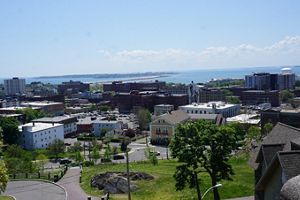 An aerial view of downtown Lynn with the ocean and Nahant beach and neighborhood in the background. 