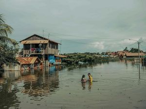  Dos niños juegan en el agua de la inundación que rodea las viviendas junto a la laguna de Yarinacocha después de que las fuertes lluvias provocaran su desbordamiento.