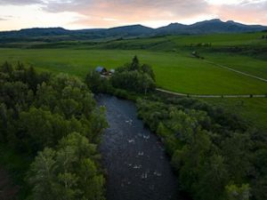 River through a green field.