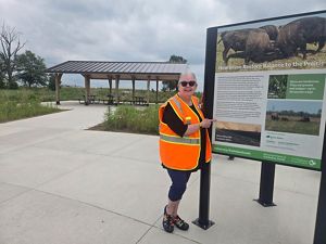 Kankakee Sands bison ranger in bright orange safety vest. 