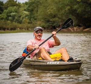 Man kayaking on Kiamichi River in Oklahoma.