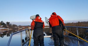 Gust Annis from TNC and Katherine Skubik from Little Traverse Bay Band of Odawa Indians, search for lake whitefish to net on a Michigan river.