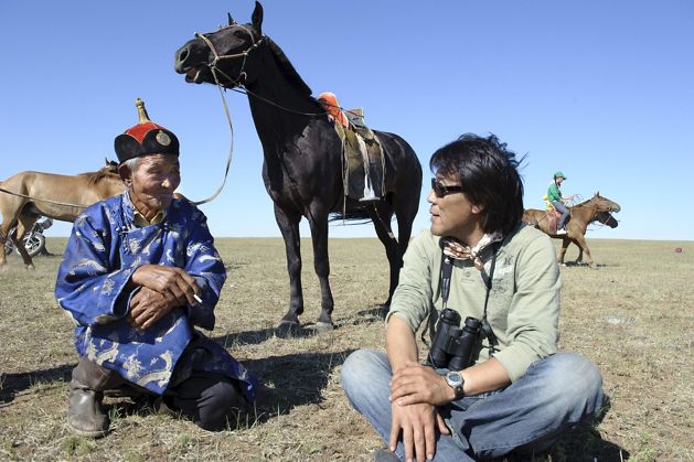 Two people chatting on the grasslands.