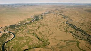 An aerial photograph features a view of grasslands in Mongolia.