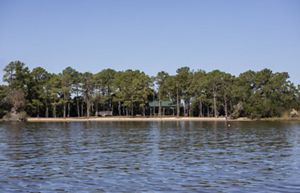Calm waters surround a forested island.