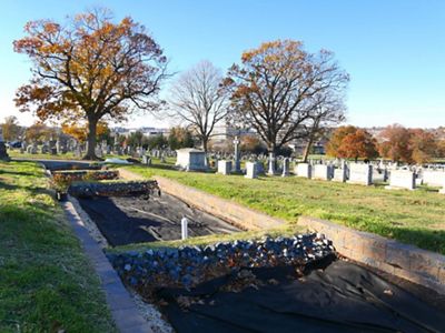 A wide lined channel intercut at spaced intervals with rock baffels provide the starting point for what will become part of a green infrastructure stormater project.