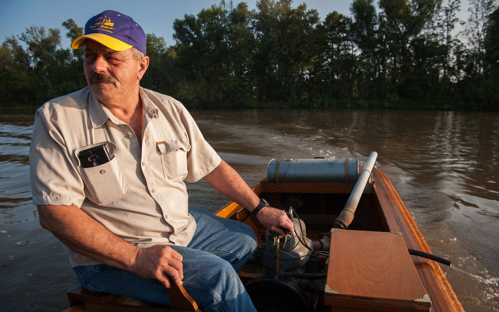
                
                  Putt-Putt Course Dana Mendoza drives his hand-crafted, cypress putt-putt boat in Bayou Sorrel, Louisiana. The flat-bottomed, motorized boats were popular about 100 years ago in the basin.
                  © Rory Doyle
                
              