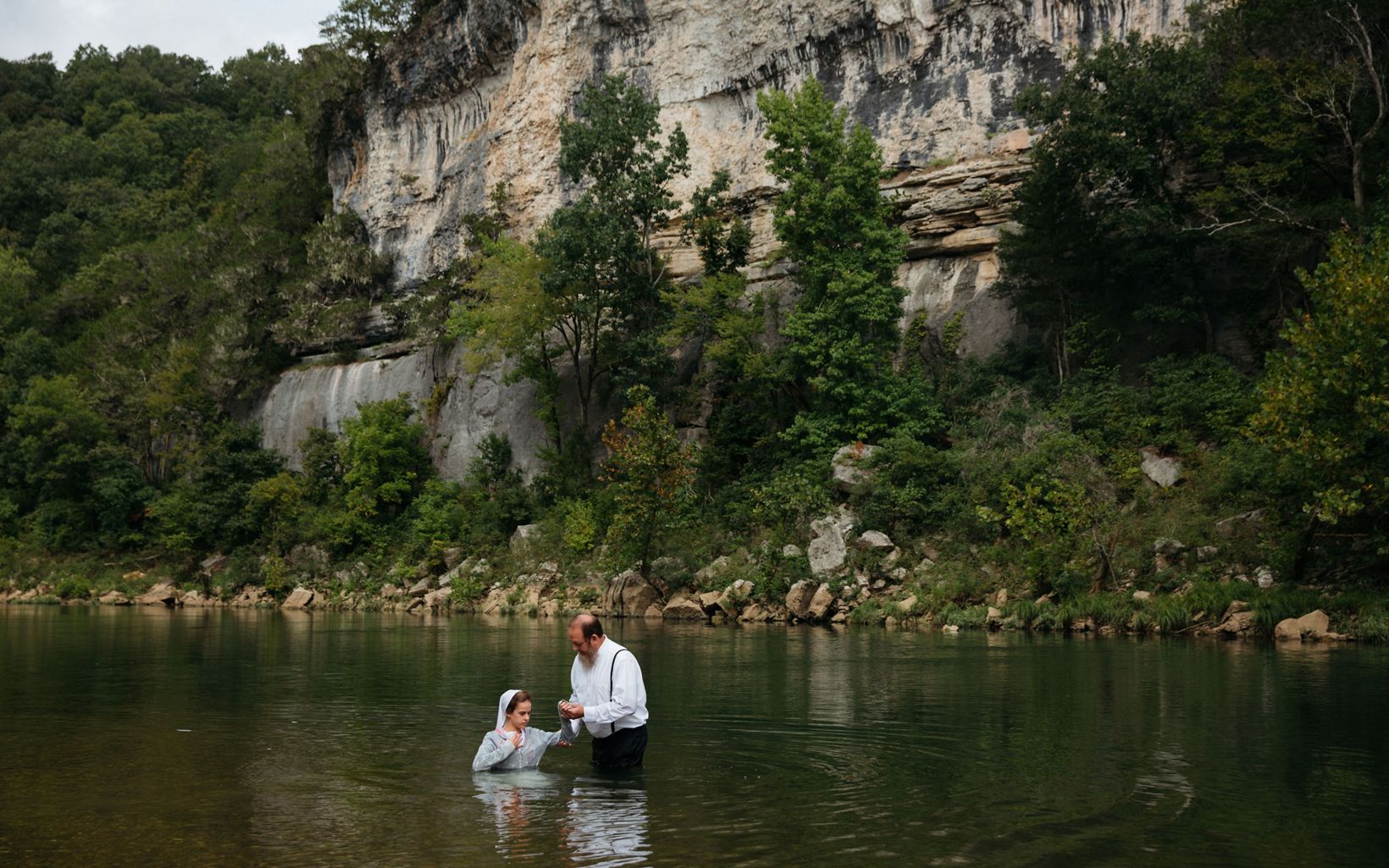 
                
                  River Baptism  Abigail Bear is baptized in the Buffalo River. She and another young adult member of their Mennonite church congregation were baptized on the same day here near St. Joe, AR.
                  © Terra Fondriest
                
              