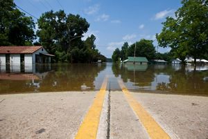 High water from mississippi river flooding a road with double yellow line in louisiana