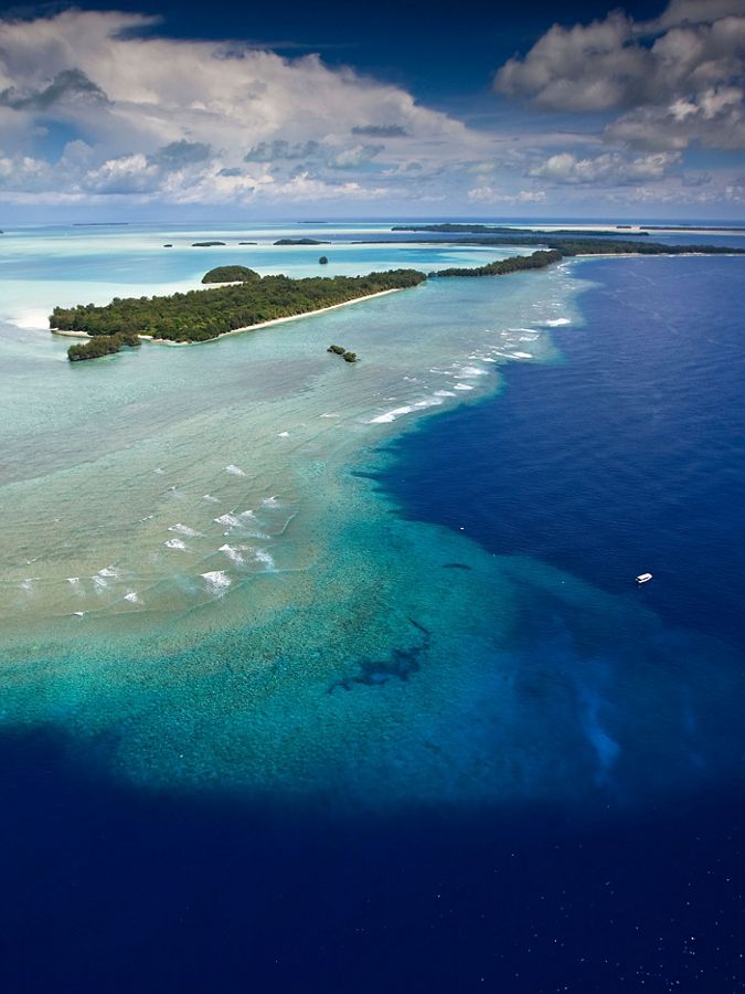 aerial view of island, blue water and sandbars