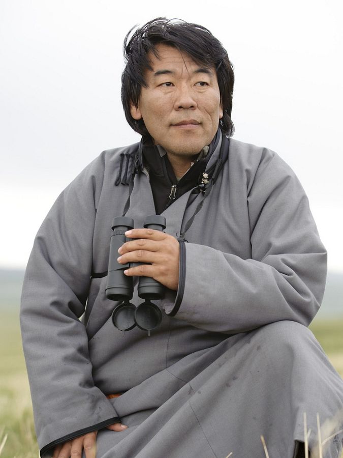 close up portrait of man outside holding binoculars