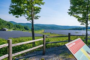 Sign that reads Elizabeth Mine with solar panel array in the background. 