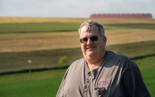 Portrait of Steve Carpenter of Redrock View Farms standing in front of some of his agricultural fields.