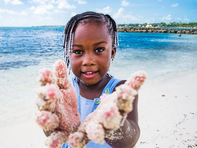 A young girl plays on a beach in The Bahamas.