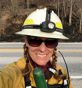 Woman wearing controlled burn gear.