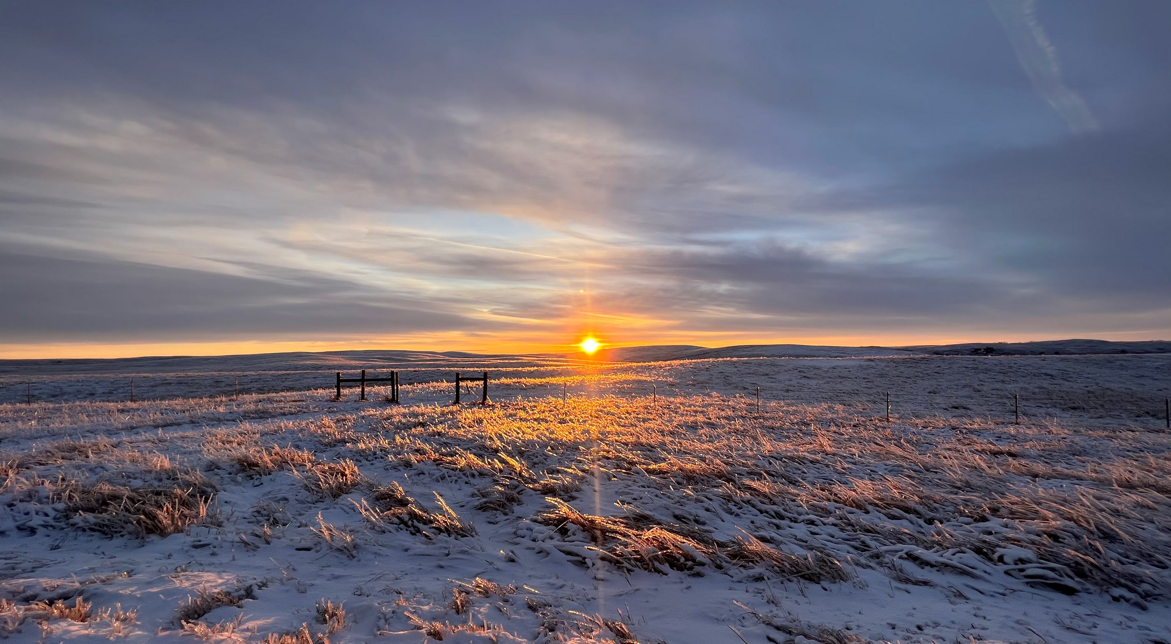 snowy Ordway Prairie under a golden sunrise.