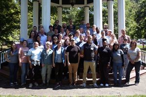 Group photo of TNC MD/DC staff. A large group of people stand together outdoors, smiling during the chapter's annual staff retreat.