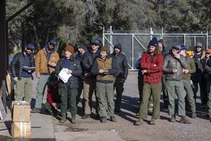 Group of people listening to instructions. 