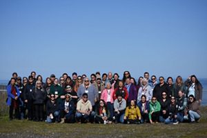 Nearly 60 participants of the 2025 EEN Gathering pose for a group photo on a sunny day at Point Haynisisoos Park.