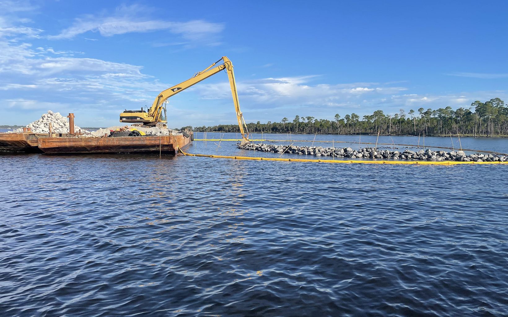 New Larger Reefs A backhoe on a barge is used to construct the reefs. © Jacobs Engineering