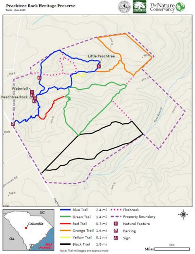 A trail map of a preserve includes red lines to reveal trails and green blobs to identify nature.