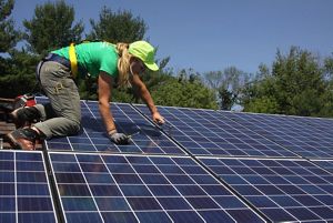Woman installing solar panels.