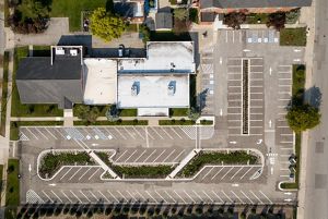 View from directly above showing a parking lot with more plantings between the rows of spots.