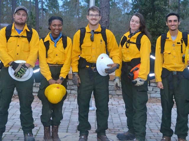 GulfCorps alum Simon Cruz Haggerty (far right) and his team during a controlled burn exercise.