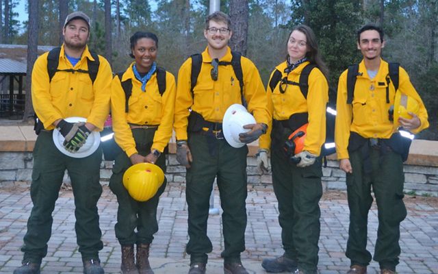 GulfCorps alum Simon Cruz Haggerty (far right) and his team during a controlled burn exercise.