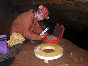 Researcher recording audio inside the cave.