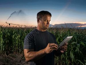 man with tablet in cornfield center pivot irrigation