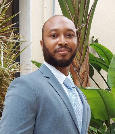 a handsome black man looking toward the camera