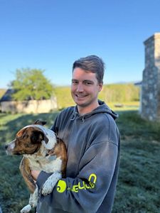 Jack Perdue holding a medium size dog.