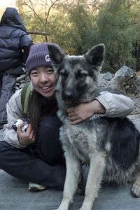 Laura Liu hugging a dog.
