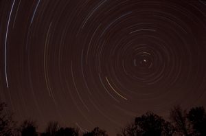 A night sky showing the brightly lit movement of stars.