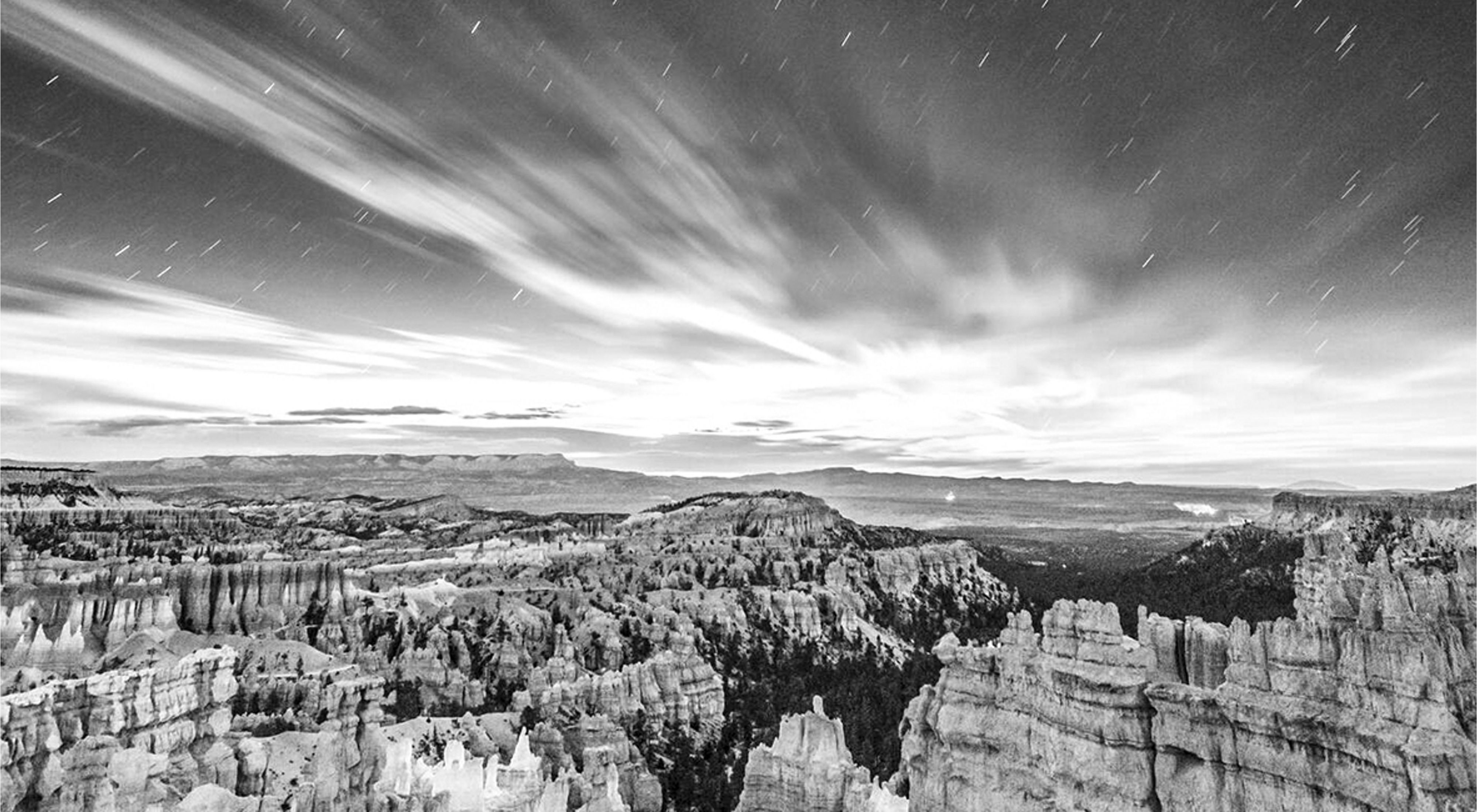 Black and white image of the moonrise over Bryce Canyon National Park in Utah.