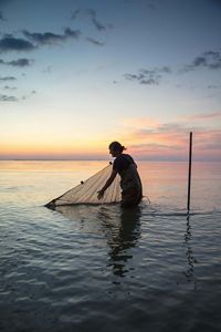 Person kayaking on lake. 