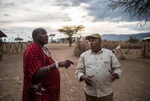 Photo of two men talking about cattle grazing in northern Tanzania.