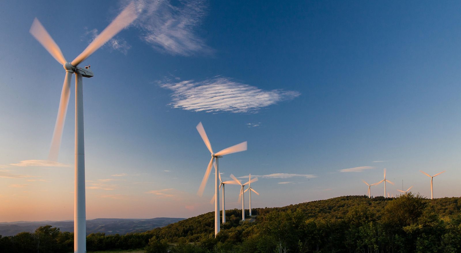 Wind farm turbines on a ridge top.