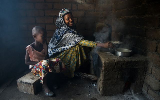 woman cooking on outdoor stove