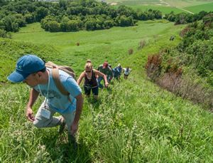 Group of hikers making their way to a high point in the Loess Hill of Iowa that is home to tremendous diversity of plants and animals which are resilient to climate change.