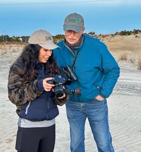 Sophia and Fred at Run Hill looking at a camera.